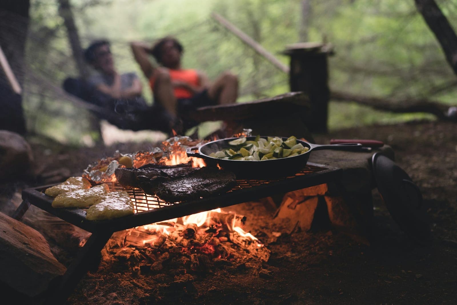 Food cooking on a grate over an open campfire